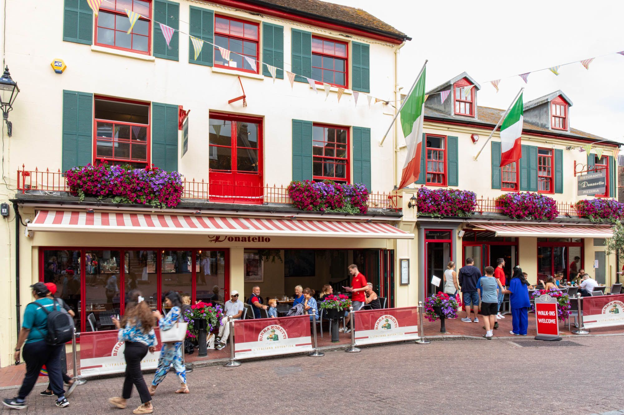 exterior shot of the Donatello, busy al fresco dining area