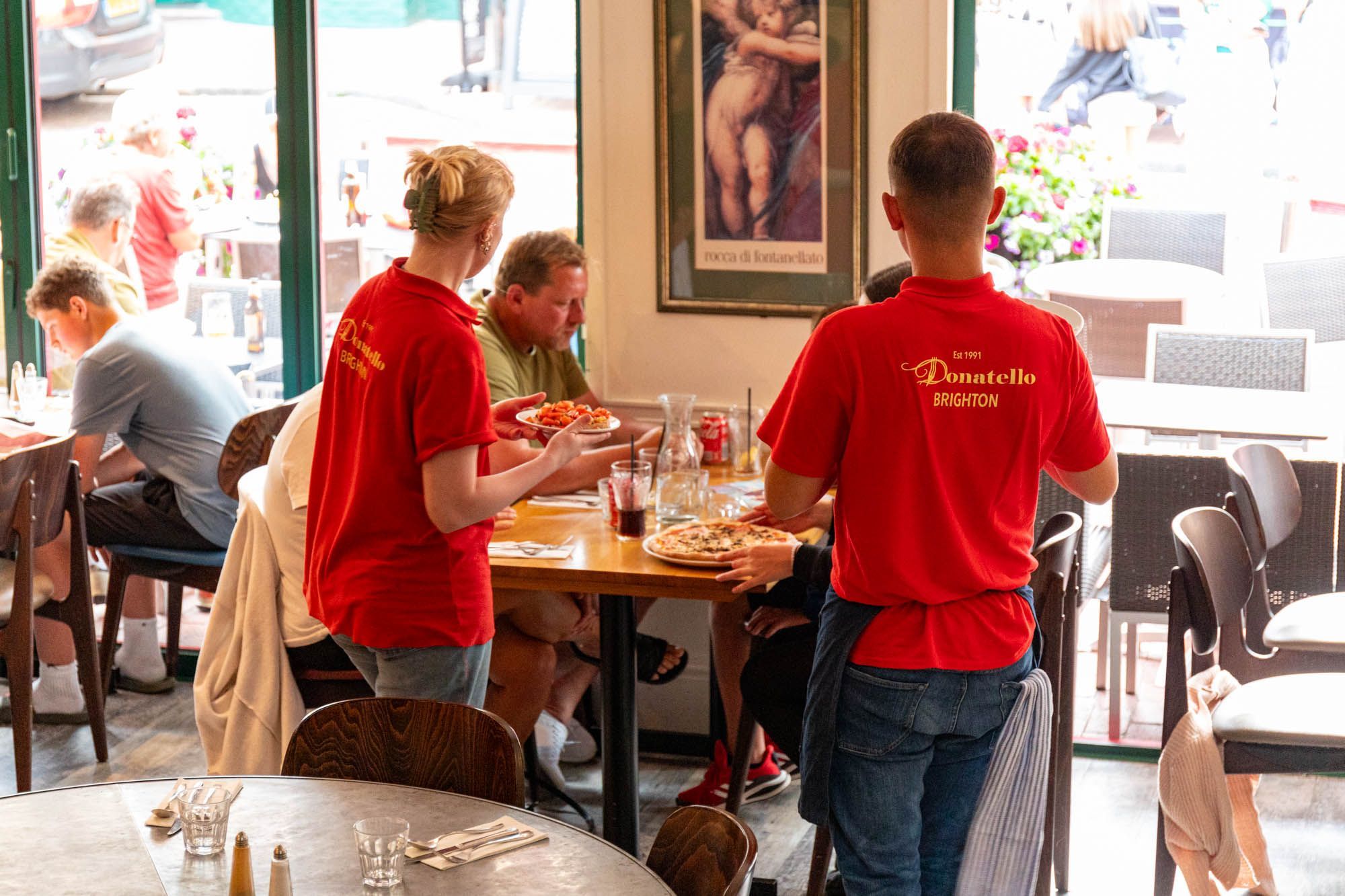 Donatello Brighton staff in red t shirts serving customers