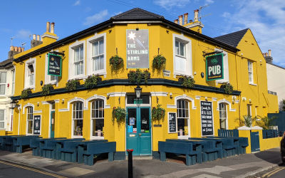 External view of pub painted yellow. Serving Italian food Restaurant Brighton