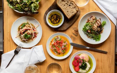 table laid out with five small dishes and drink