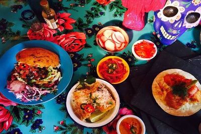 Colourful Mexican dishes with tacos, rice burrito bowls and vegetable sides.