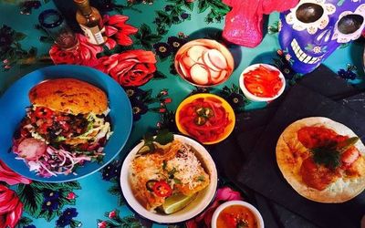 Colourful Mexican dishes with tacos, rice burrito bowls and vegetable sides.