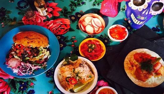Colourful Mexican dishes with tacos, rice burrito bowls and vegetable sides.