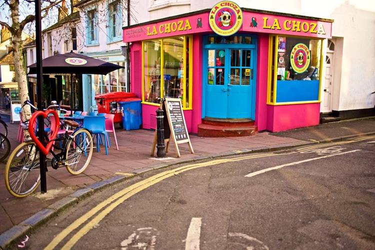 La Choza Brighton. A picture of their facade which is brighton pink, yellow and blue. 
