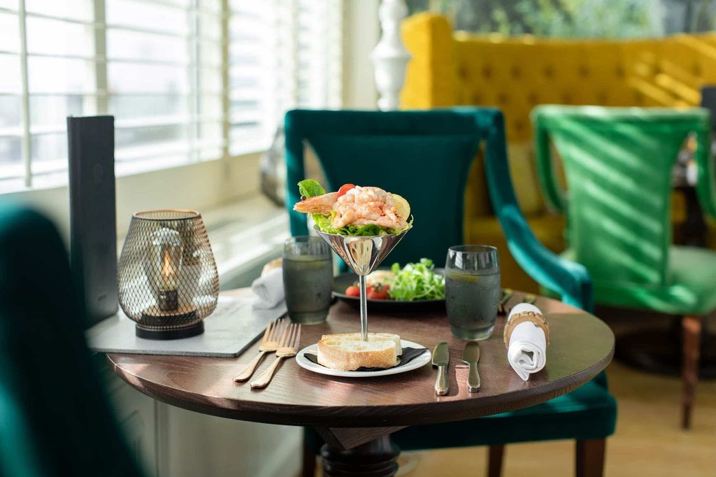 side photo of the pretty dining area at the grand hotel, prawn cocktail on the table