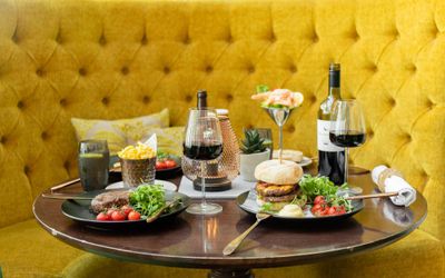 The Grand Brighton Grill Victoria Terrace table laid pout for two with the yellow soffa in backgroud