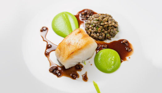 Little Fish Market Brighton. Their Set Menu which is a white plate with fish and a pea reduction.