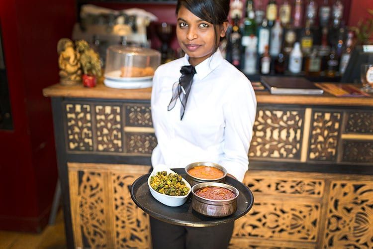 Serving Indian dips and sides at Chaula's, Lewes
