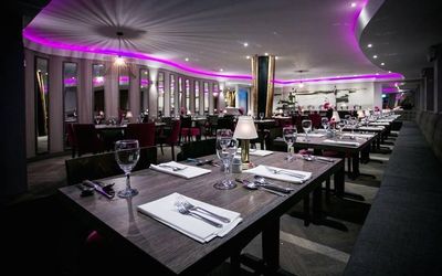 Interior shot of the restaurant with a monochrome theme and colourful lights