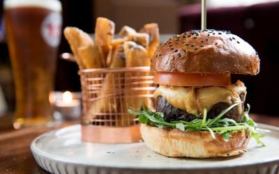 A giant main course, stacked with sunflower shoots, tomato and cheese in a seeded bun. Served with a basket of chips and a pint of beer. pubs in hove, Hove Place Bistro