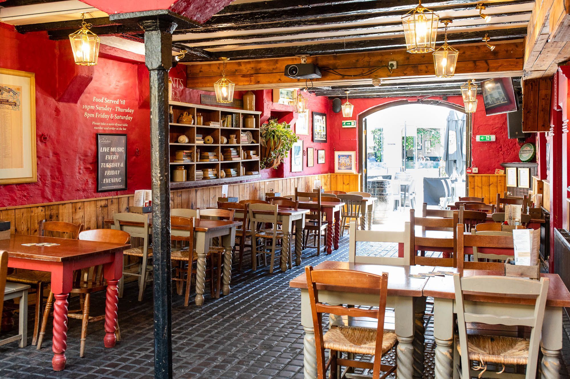 interior of the cricketers pub, red walls, brown tables and chairs