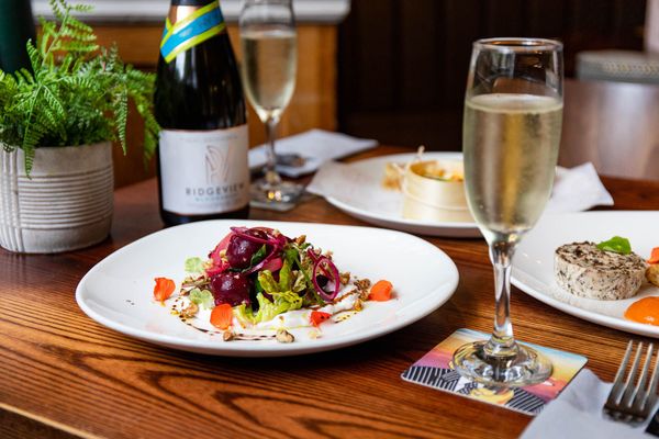 beetroot salad dish served with glass of ridgeview prosecco