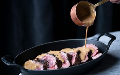 filet steak being poured with mushroom sauce
