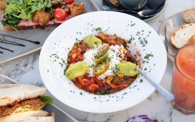 table served with brunch dishes and cocktails