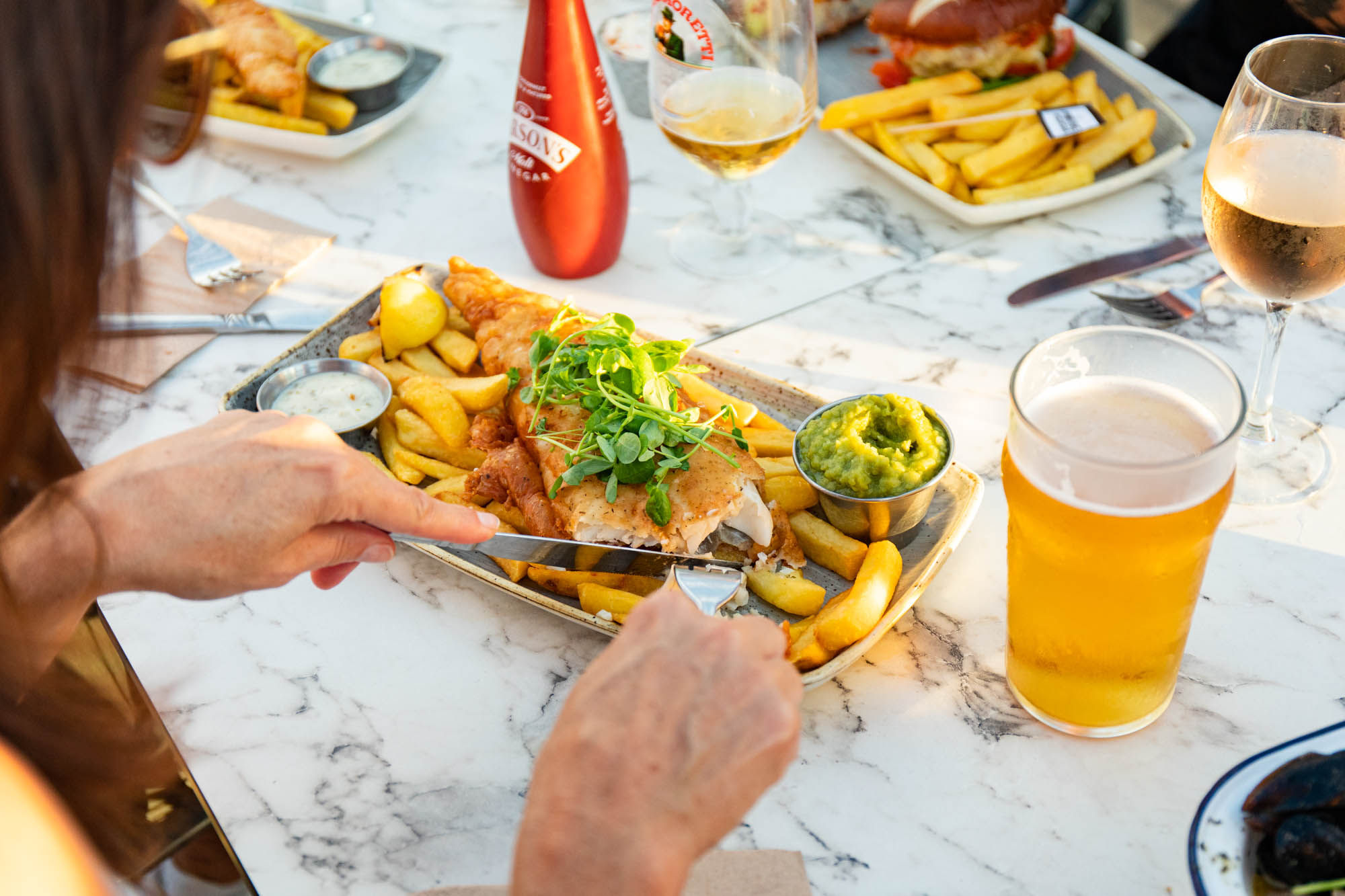 woman eating fish and chips