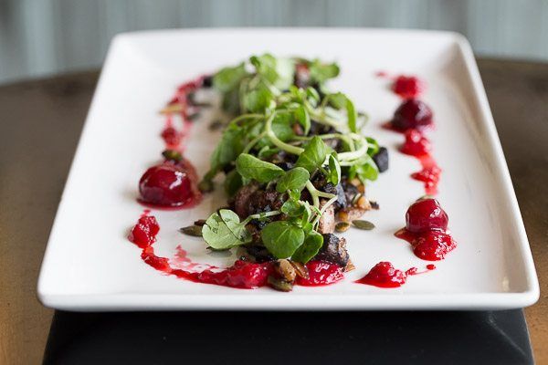 Burns Night Brighton, Salad on white plate. Salad dressed with lambs lettuce and rasberry coulis