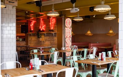interior shot of the Ohso Brighton. Long wooden tables with mint metal chairs