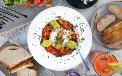 table served with brunch dishes and cocktails