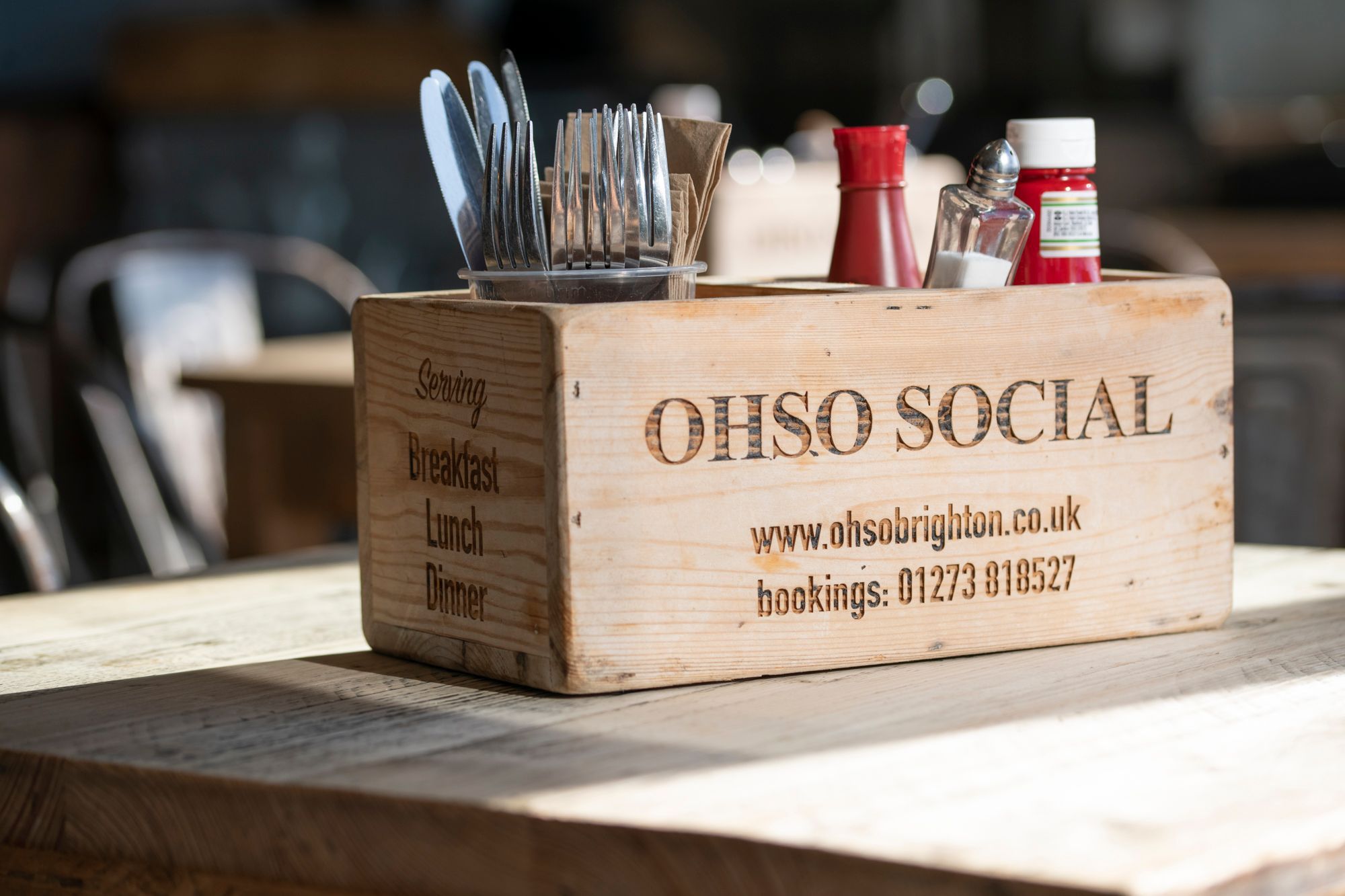 wooden box with cutlery and sauces in