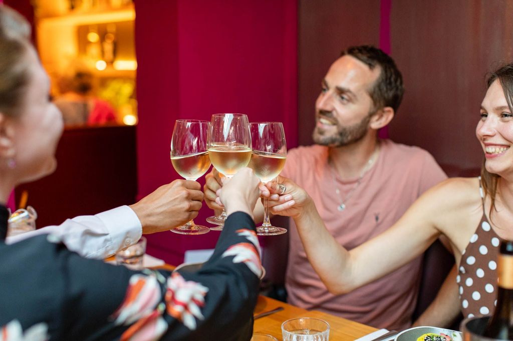 group of friends having a toast by the tablel in Terre a Terre. Located in The Lanes Brighton