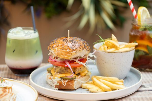 delicious looking burger served with fries and drinks at Moksha Brighton.
