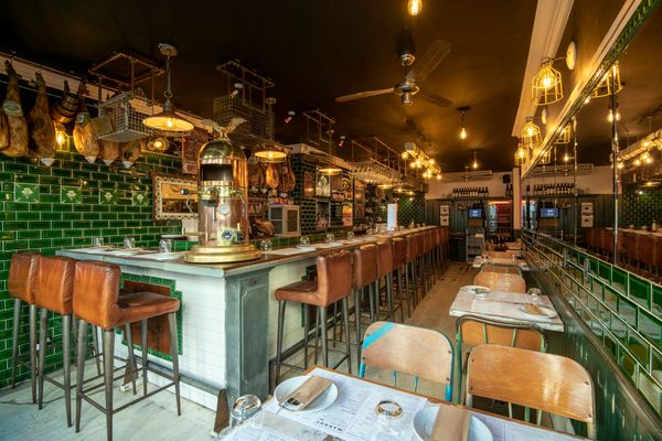 market's interior with green tiles and bar side dining. Tapas. Part of our fish restaurant Brighton round up