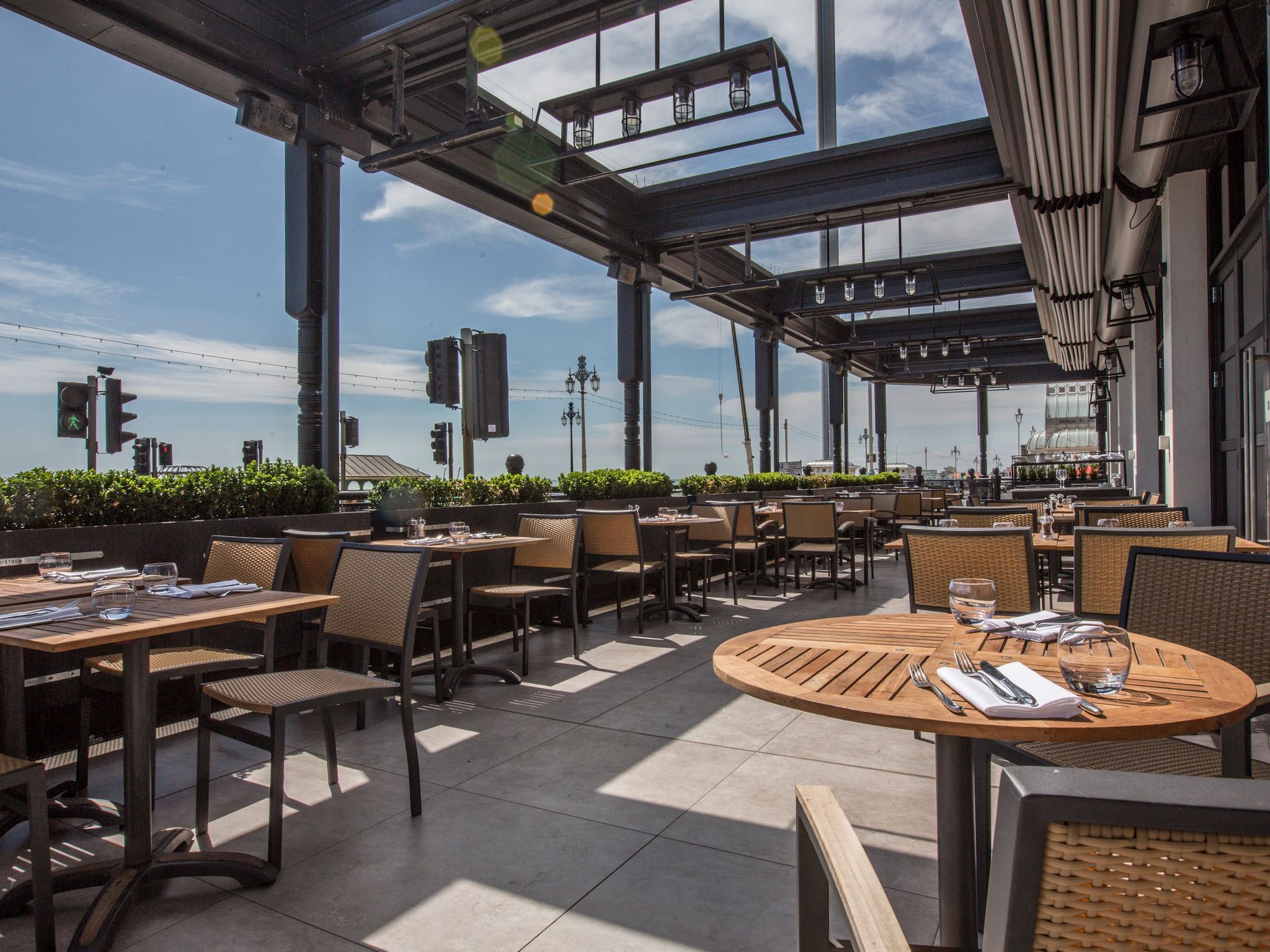 Sunny seafront terrace with an sky view and large windows