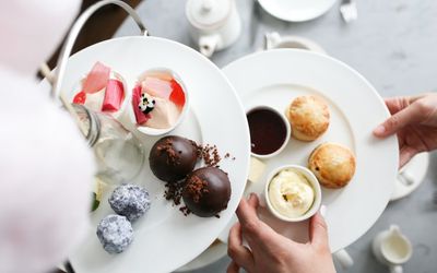 Afternoon tea with scones, chocolate truffles and a rhubarb dessert.