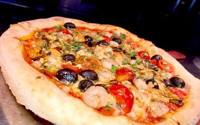 Fresh pizza with prawns, olives tomato and chilli