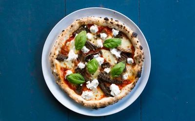 RB MARCH Sat 27th 3.55pm - Pizza picture from above against a blue table, topped with ricotta, fresh basil and tomato