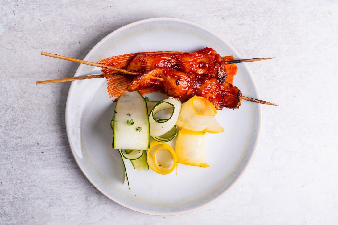 small plate dish consisting of skewers. Fourth and Church tapas on a white plate. 