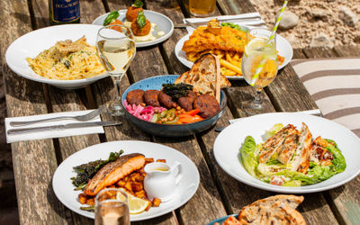 side shot ot the table in the garden laid out with lunch dishes at The Better Half