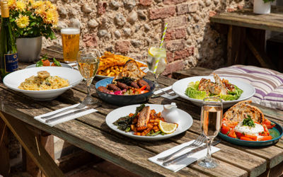 side shot ot the table in the garden laid out with lunch dishes at The Better Half