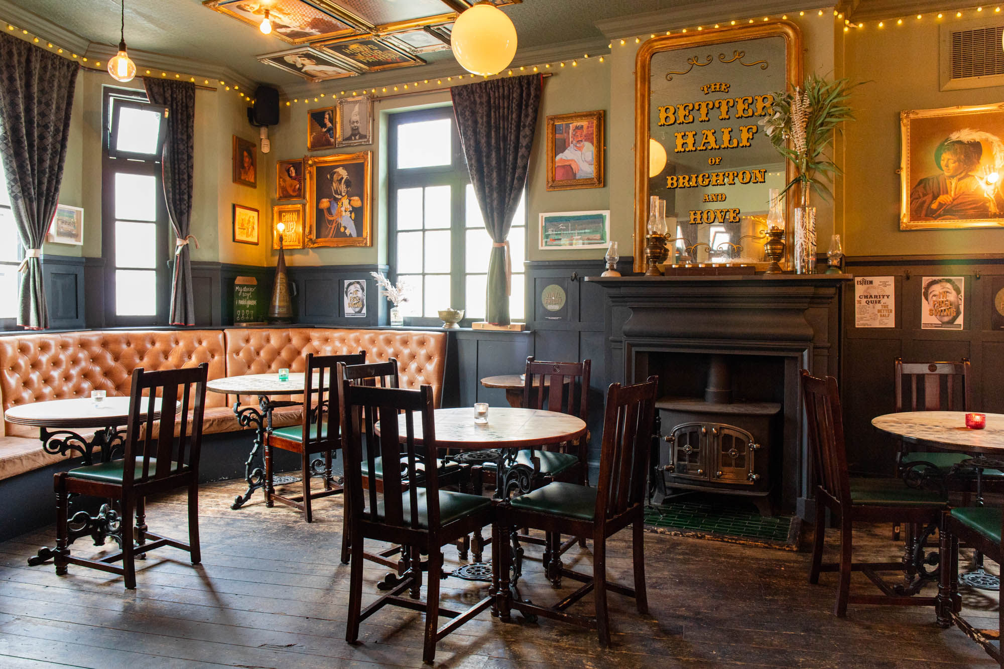 orange diner seats, brown tabes and chairs. dim lights. wall decorations. Better Half Pub