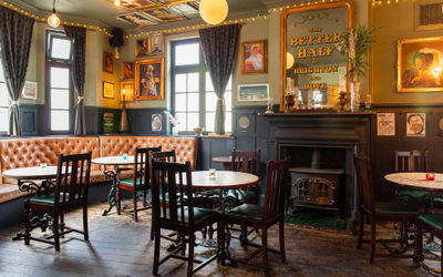 the Better Half pub. backdrop of mirrors and traditional pub furniture. Part of the Christmas party Brighton guide