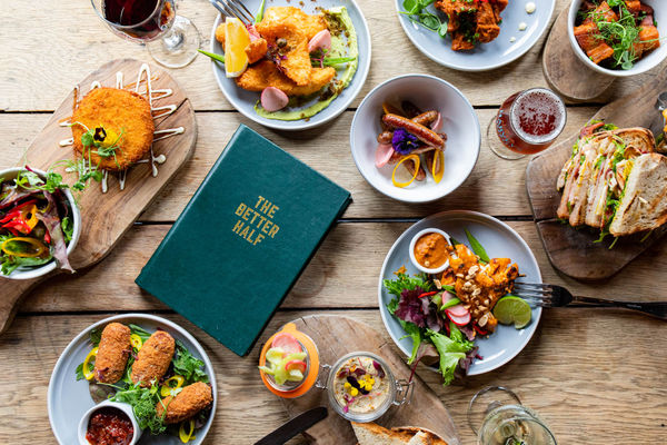 over head shot of the dishes served on brown table, the Better half. Brighton restaurants lunch guide. Gastro Pubs Brighton and Hove