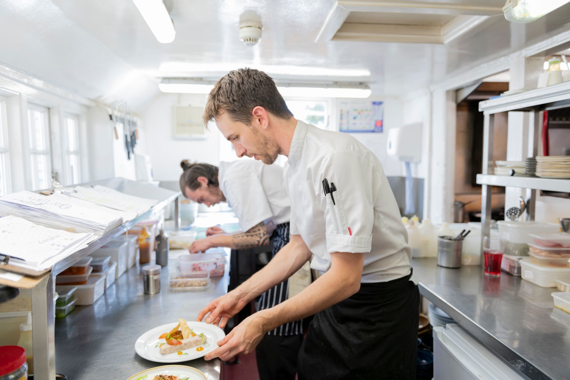 chef holding plate with the dish on it