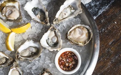 Oyster platter on ice with lemon and mignonette sauce. Fish Brighton Restaurant, seafood restaurant. Riddle and Finns is a popular restaurant on Brighton seafront above Shelter Hall