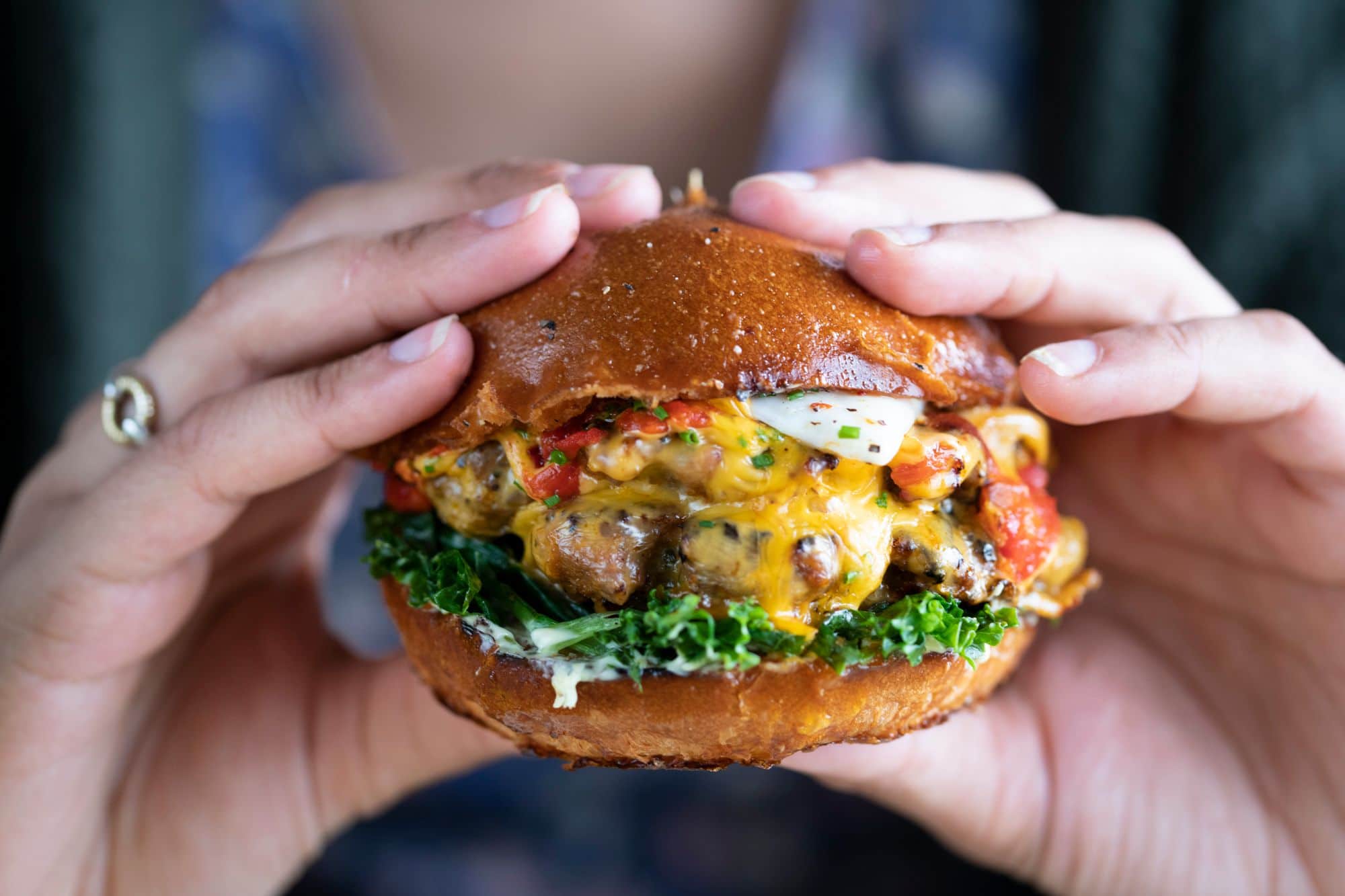 person holding delicious burger