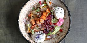 Roasted vegetable and egg salad served in a ceramic bowl at Lucky Beach Brighton on the beach