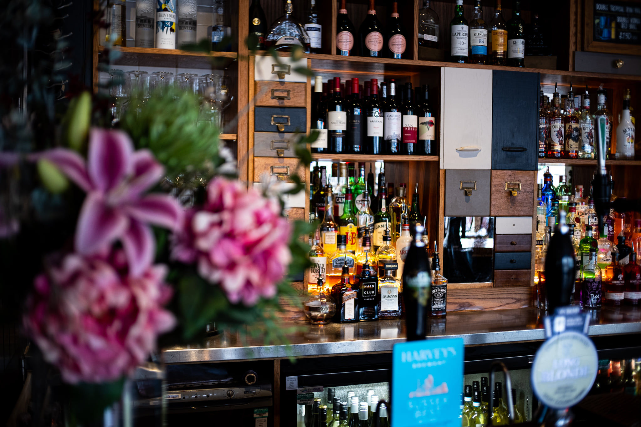 inside the libation bar in hove, lot of alcoholic drinks on the shelves
