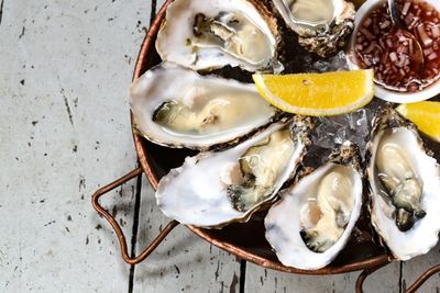 A platter of large oysters with fresh lemon and shallot vinegar
