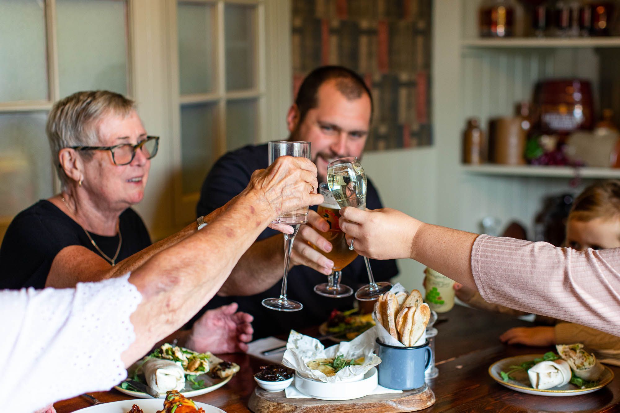 group of people by the table at Ladies Mile having a toast