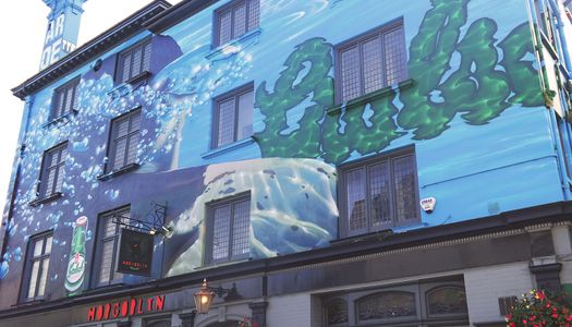 A four story pub painted with a blue mural and a sign saying The Hobgoblin Brighton