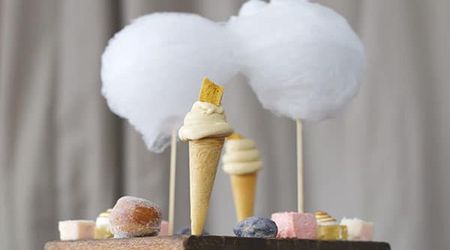 A fun seaside themed dessert with min ice cream cones and sticks of candy floss