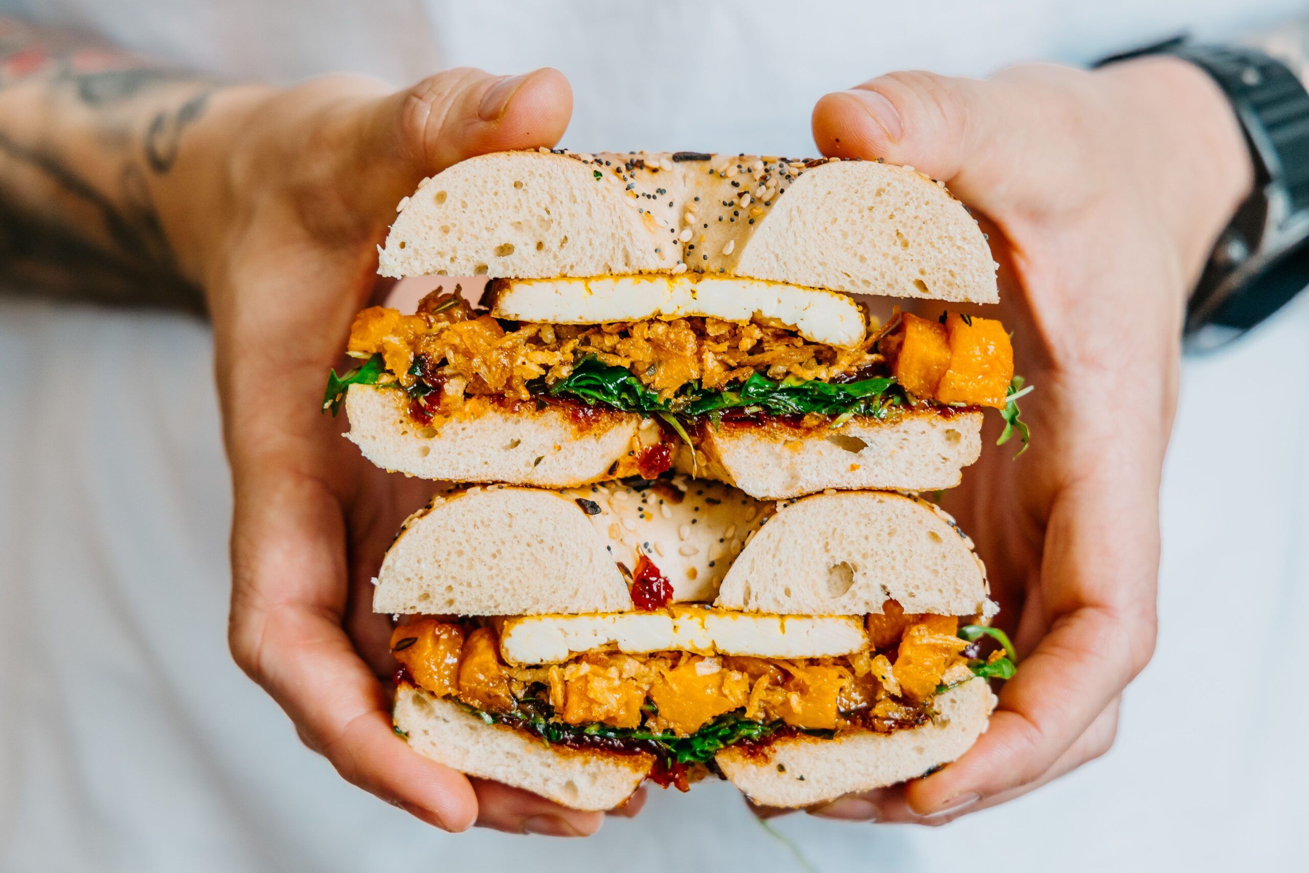 hands holding two bagels