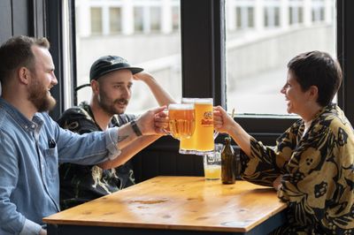 Friends toasting with pints. Six nations Championship. Where to watch rugby in Brighton