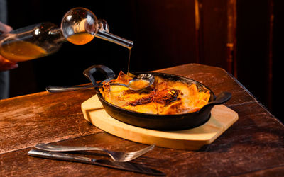 Bohemia_Autumn Menu_51 oil being poured over lasagna at Bohemia Brighton