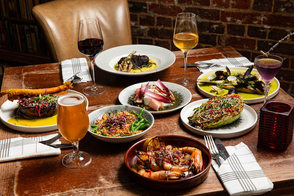 BOHEMIA BRIGHTOn - table laid out with small plate dishes and glasses of wine and beer
