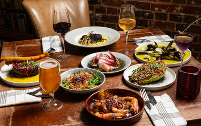 BOHEMIA BRIGHTOn - table laid out with small plate dishes and glasses of wine and beer